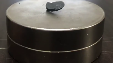 A pellet of LK-99 being repelled by a magnet