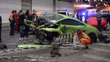 This photo taken early on April 12, 2015 shows a badly damaged Lamborghini car and debris in a tunnel after a crash involving a Ferrari in Beijing