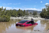 A screenshot from a Wham Baam Teslacam video depicting Tesla Model 3 driver "Ryan" in his car in a puddle in California