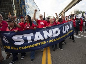 UAW President Shawn Fain marches with UAW members through downtown Detroit after a rally in support of the United Auto Workers members as they strike the Big Three auto makers on September 15, 2023 in Detroit, Michigan