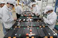 This photo taken on March 12, 2021 shows workers at a factory for Xinwangda Electric Vehicle Battery Co. Ltd, which makes lithium batteries for electric cars and other uses, in Nanjing in China's eastern Jiangsu province