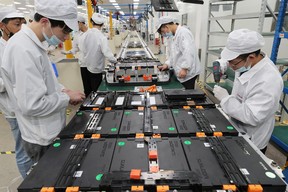 This photo taken on March 12, 2021 shows workers at a factory for Xinwangda Electric Vehicle Battery Co. Ltd, which makes lithium batteries for electric cars and other uses, in Nanjing in China's eastern Jiangsu province