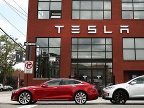 Tesla vehicles sit parked outside of a new Tesla showroom and service center in Red Hook, Brooklyn on July 5, 2016 in New York City