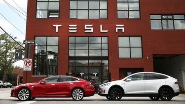 Tesla vehicles sit parked outside of a new Tesla showroom and service center in Red Hook, Brooklyn on July 5, 2016 in New York City