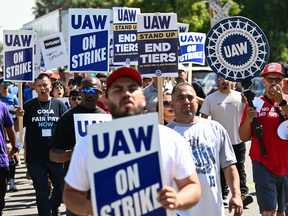 Members of the United Auto Workers (UAW) Local 230 and their supporters walk the picket line in front of the Chrysler Corporate Parts Division in Ontario, California, on September 26, 2023, to show solidarity for the "Big Three" autoworkers on strike