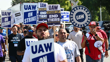 Members of the United Auto Workers (UAW) Local 230 and their supporters walk the picket line in front of the Chrysler Corporate Parts Division in Ontario, California, on September 26, 2023, to show solidarity for the "Big Three" autoworkers on strike