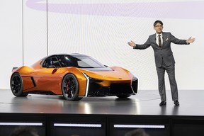 Koji Sato, Toyota CEO, with Toyota concepts at the 2023 Japan Mobility Show