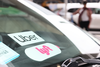 A Lyft decal is seen on a car in the pick-up area at JFK Airport on April 28, 2023 in New York City