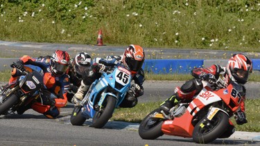 Rhys McNutte leads, in order, Ashton Parker, Ben Hardwick, and Lincoln Scott at a 2023 MiniGP race at Greg Moore Raceway in B.C.