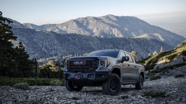 The 2023 GMC Sierra 1500 AT4X AEV Edition driving on a rocky hillside. The AT4X AEV Edition delivers extreme off-road capability without compromising on-road comfort.