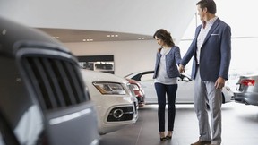 Woman at a car dealership