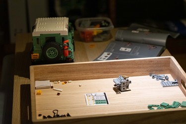 A LEGO kit being assembled on a bench