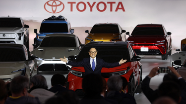 Toyota president Akio Toyoda gestures at a briefing on EV (electric vehicle) battery strategies at the company's showroom in Tokyo on December 14, 2021
