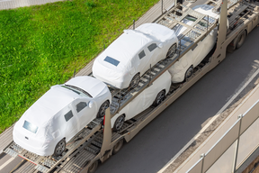 New cars being transported by truck