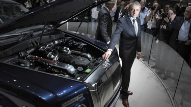 CEO of Rolls-Royce carmaker Torsten Müller-Otvös (center) and British humorist Rowan Atkinson a.k.a. ‘Mr. Bean’ present a car
