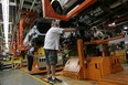 Ford employees work on the line at an assembly facility in Oakville, Canada.