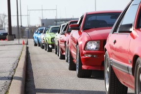 Classic Ford Mustangs assemble at the Ford Essex Engine Plant in Windsor, Ontario on April 14, 2024 to celebrate the model's 60th anniversary