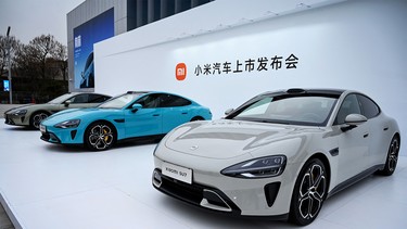 Chinese electronics company Xiaomi's first electric vehicles, the Xiaomi SU7 range, are seen on display at a launch event in Beijing on March 28, 2024