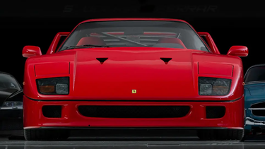 A 1990 Ferrari F40 – flanked by a Bugatti Veyron, left; and a Mercedes-Benz 300 SL roadster – from the 'Dare to Dream' Collection of Miles Nadal, in Toronto
