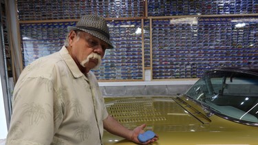 Fred Bottcher using a clay bar on his customized 1957 Cadillac