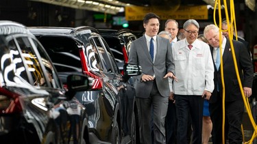 Prime Minister Justin Trudeau, left, and Ontario Premier Doug Ford, right, tour a Honda manufacturing plant in Alliston, Ont., on April 25, 2024.