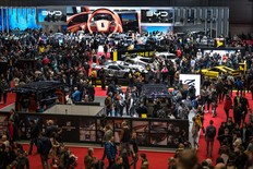 Visitors are seen during the first public day of the Geneva International Motor Show in Geneva, on February 28, 2024