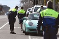 Police officers pull a car over for a licence and permit check in Melbourne on August 11, 2020, during a strict stage four lockdown of the city due to a COVID-19 coronavirus outbreak