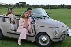 Italy's Prime Minister Giorgia Meloni (center) arrives on a small Fiat beach car to attend a flags ceremony at Borgo Egnazia Golf Club San Domenico during the G7 Summit, hosted by Italy in Apulia region, on June 13, 2024 in Savelletri