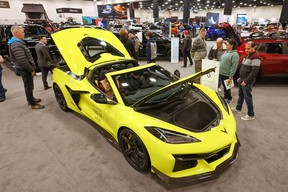 Visitors check out a Chevrolet Corvette during the 2024 Calgary International Auto and Truck Show.