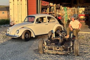 Annie Van Orman with her 1969 Beetle, a car she calls Helen, and her latest project, a 1968 Beetle — well, just the pan. Van Orman restored Helen over a four year period, and did the majority of the work herself. There are now more than 4,000 post-restoration miles on its odometer.