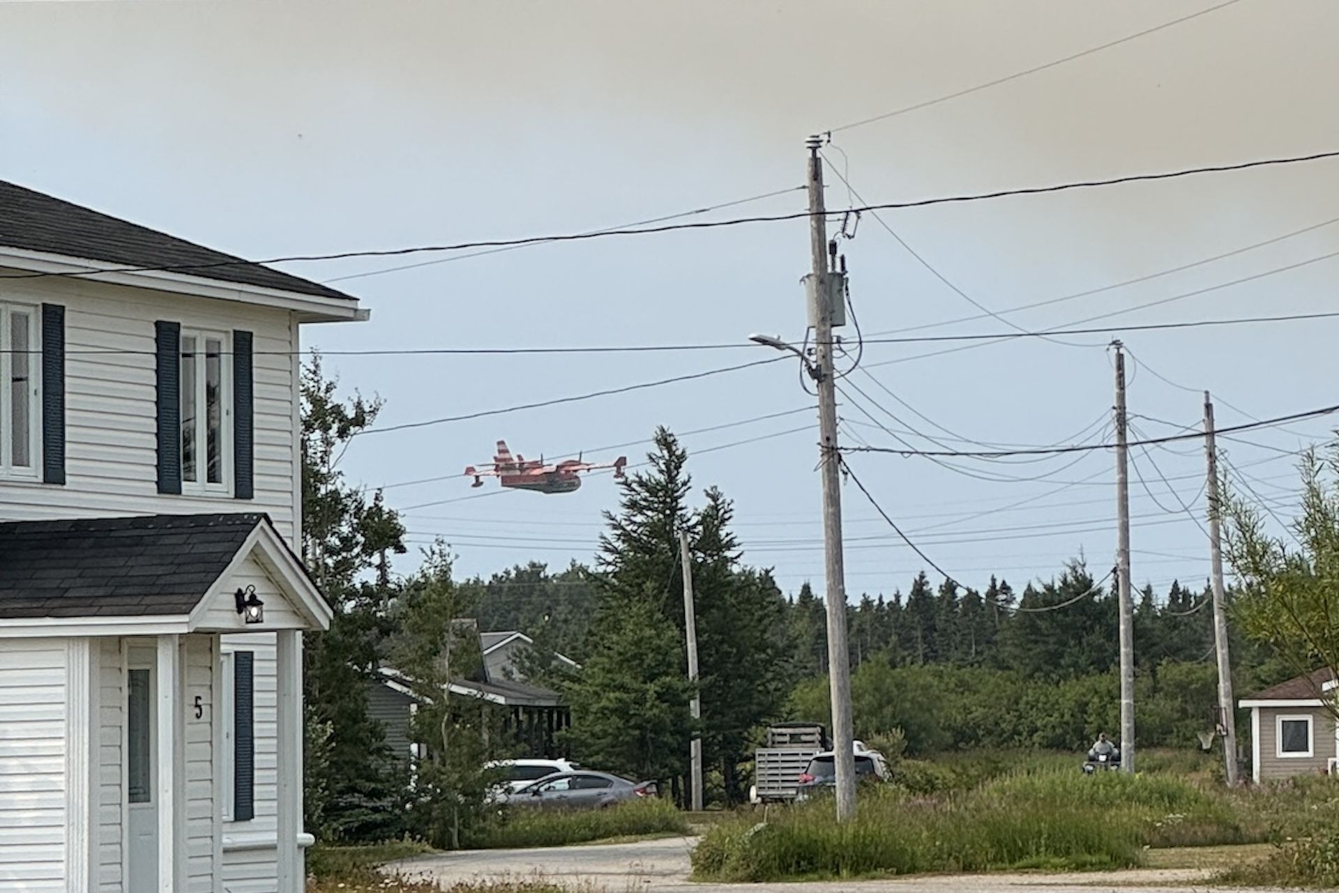 Water bombers fly low to fight a Newfoundland wildfire in 2025