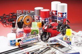 A Tamiya scale model of a Ducati motorcycle, surrounded by various Tamiya building accessories