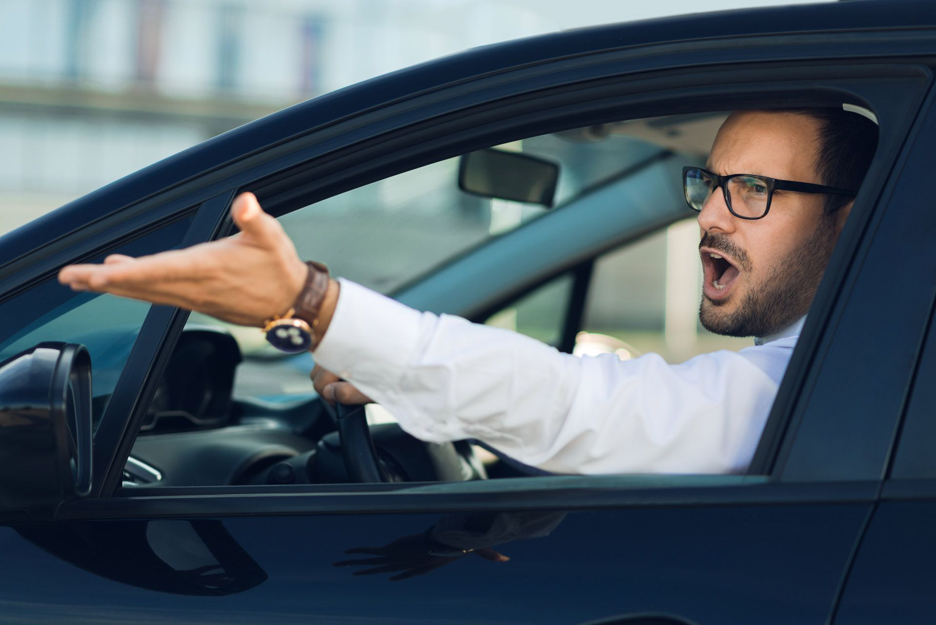 An angry driver yelling out of a car window