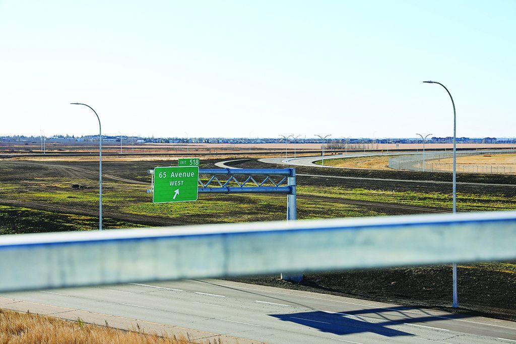 Highway 2 signs for the new 65 Avenue exit and interchange.