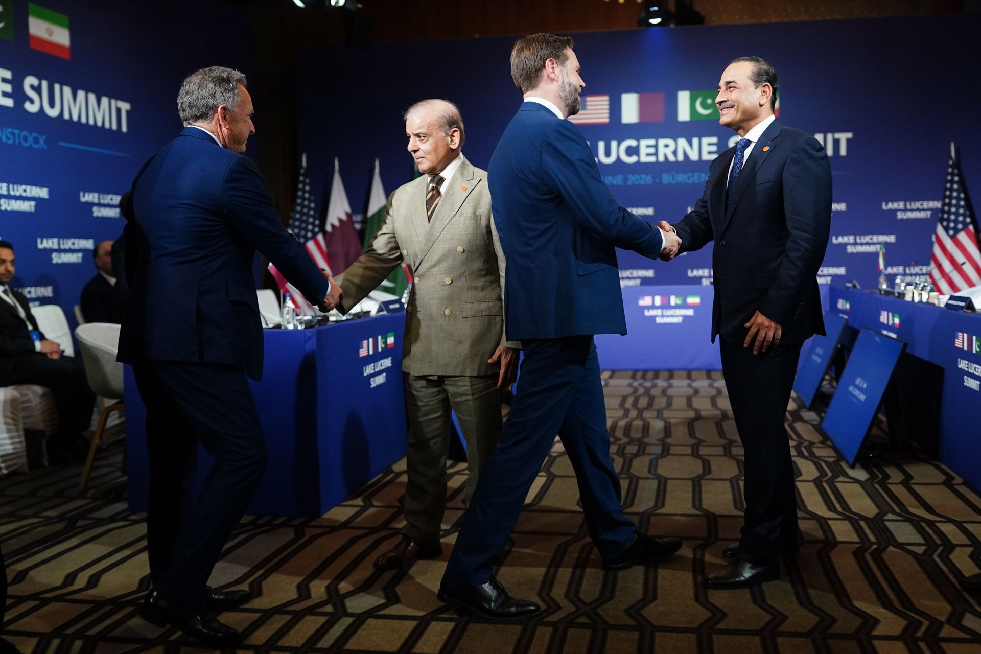 U.S. President Donald Trump's special envoy Steve Witkoff (far left), Pakistan's Prime Minister Shehbaz Sharif (left), U.S. Vice President JD Vance (right) and Pakistan's Chief of Army Staff Field Marshal Asim Munir (far right) greet each other at the start of a quadrilateral meeting between the U.S., Iran, Pakistan, and Qatar at the Lake Lucerne Summit, aimed at advancing a deal to end the Middle East conflict at the Buergenstock Resort, Lake Lucerne on June 21, 2026 near Stansstad, Switzerland