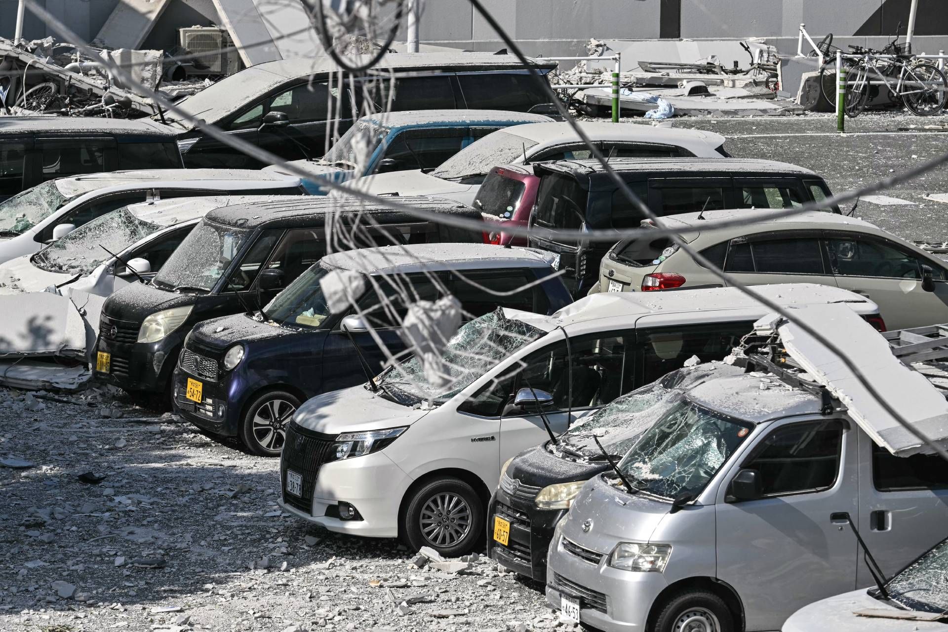 A general view shows damaged cars parked outside the Aeon Mall Kumamoto in Kashima, Kumamoto Prefecture, on July 29, 2026, after an earthquake struck southwestern Japan the previous day