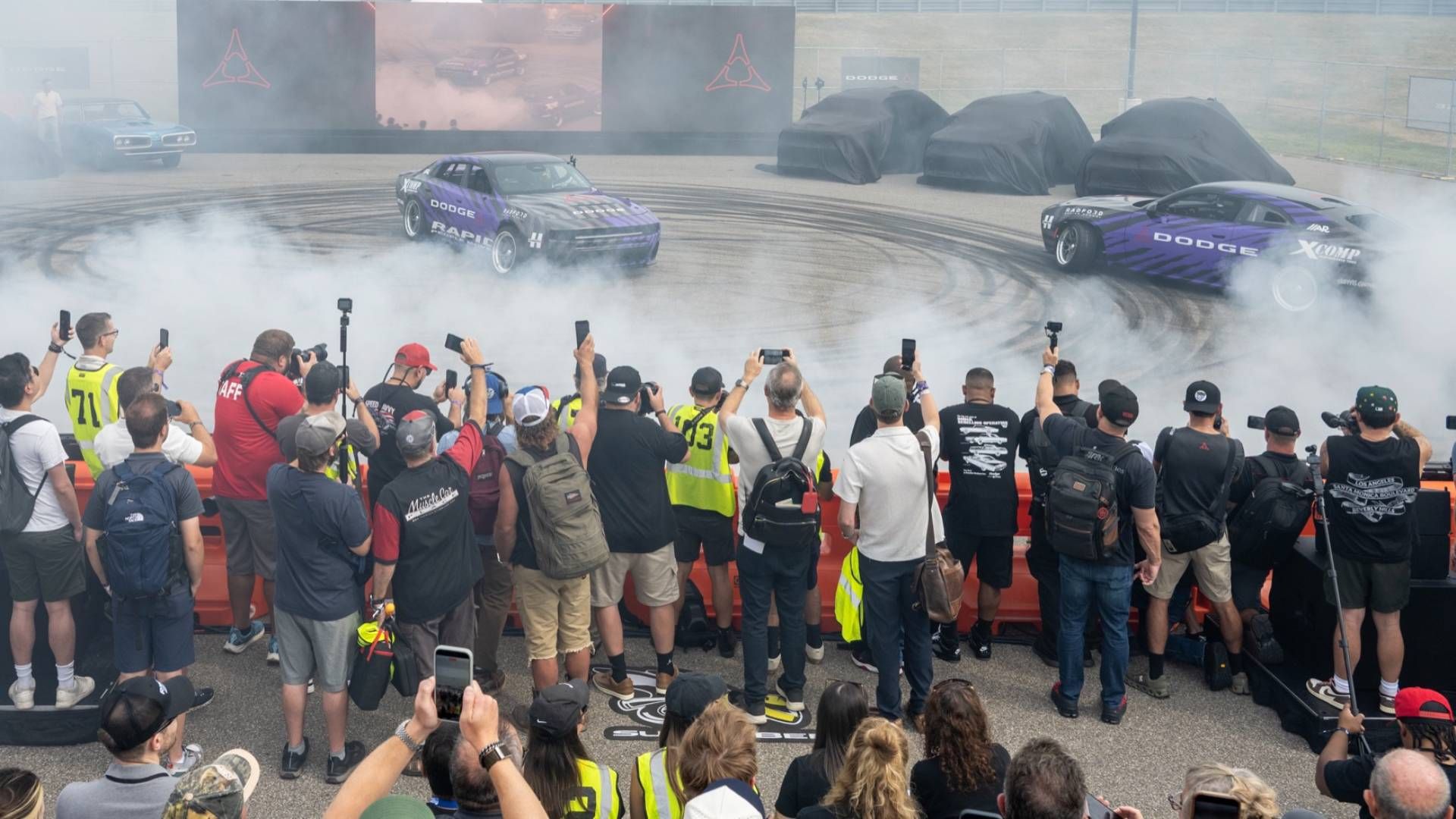 Media at the Roadkill Nights Powered by Dodge press preview on August 7, 2026 capture the smoke-filled introduction of the two-door Dodge Charger Boost Coupe and four-door Dodge Charger RPM (Rapid People Mover), two new professional-spec Dodge Charger Scat Pack drift machines