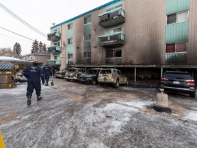 Investigators inspect a fire in an apartment ground level parkade at 8516 99 Street on Wednesday, Feb. 15, 2023 in Edmonton. Greg Southam-Postmedia