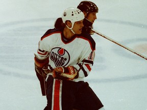 Edmonton Oilers winger Esa Tikkanen tangles with Los Angeles Kings centre Wayne Gretzky in 1990.