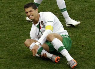  Portugal's Cristiano Ronaldo reacts after being tackled during a World Cup group G soccer match against Ivory Coast at Nelson Mandela Bay Stadium in Port Elizabeth, South Africa, Tuesday, June 15, 2010. Ronaldo is among those who tumble and feign injury.  
