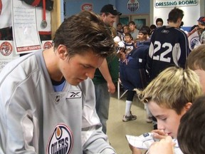 Anton Lander signs autographs for some young fans at last July's summer development camp in Edmonton. This week he has signed a more important document, a three-year entry-level contract with the Oilers.
