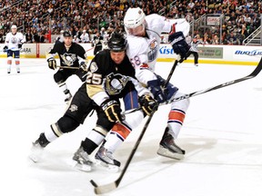 Jeff Petry #58 of the Edmonton Oilers battles for control of a loose puck (Photo by Jamie Sabau/Getty Images)