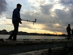 Journal photographer Shaughn Butts (@thegearhound) gets ready to try an underwater shot in Summerside. Photo by Elise Stolte / Edmonton Journal.