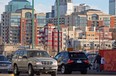 A woman walks through Oliver Square in front of a crowded looking skyline on Tuesday November 17, 2009.  Photo by John Lucas/Edmonton Journal