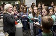 Karen Unland leads students from the City Hall School through the newsroom as part of their visit to the new media lab.