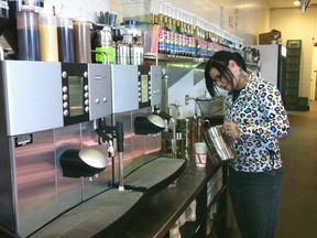 Shawna Saunders makes a chai latte at the new Jasper Avenue location of Remedy Cafe. Photo by Elise Stolte / Edmonton Journal