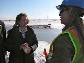 March 28, 2012. Progressive Conservative leader Alison Redford talks to Suncor environmental specialist Christine Daly about a water sample taken from the company's Wapisiw Lookout reclaimed talings pond. Redford made the stop on the third day of the 2012 election campaign.