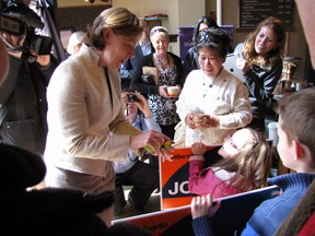 Progressive Conservative leader Alison Redford receives an Easter egg filled with chocolates from Francesca and Christian Mason at a campaign stop at a Calgary coffee shop on Monday.