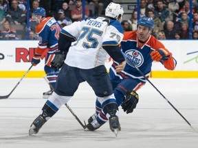 Like most action photos of Darcy Hordichuk, there isn't a puck in sight. Here the Oilers' tough guy throws down with Ryan Reaves of St. Louis.