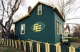 Dave McGregor gave the Bonnie Doon house its first green-and-gold makeover in 1997 and the colours remain to this day, though perhaps a little worse for wear. Photo by Brian Gavriloff / Edmonton Journal